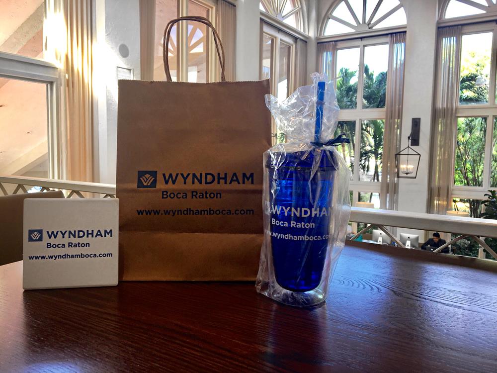 Customer photo from Stephanie of our Kraft Paper White Shopping Bag - 13" x 10", a bag and a cup on a table