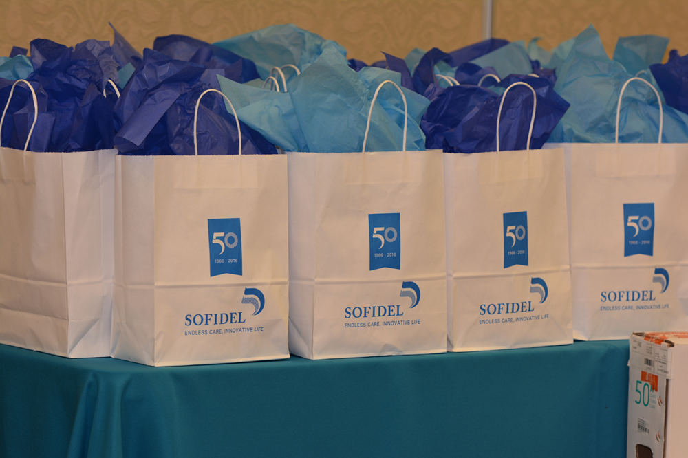a group of white bags with blue wrapping paper on a table