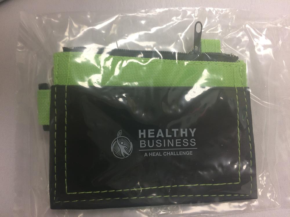 a black and green pouch in a clear plastic bag