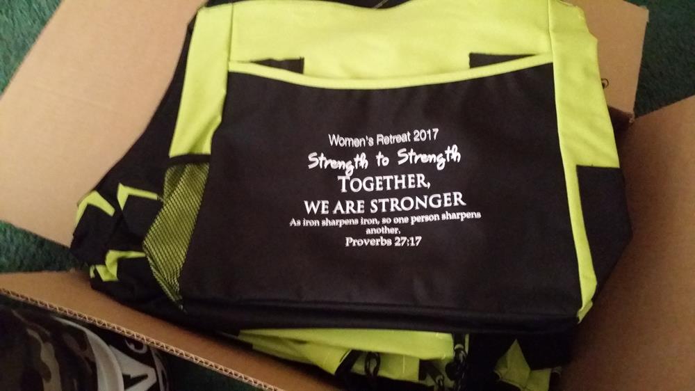 Customer photo from tiana of our Two-Tone Tote Bag, a black and yellow bag with white text