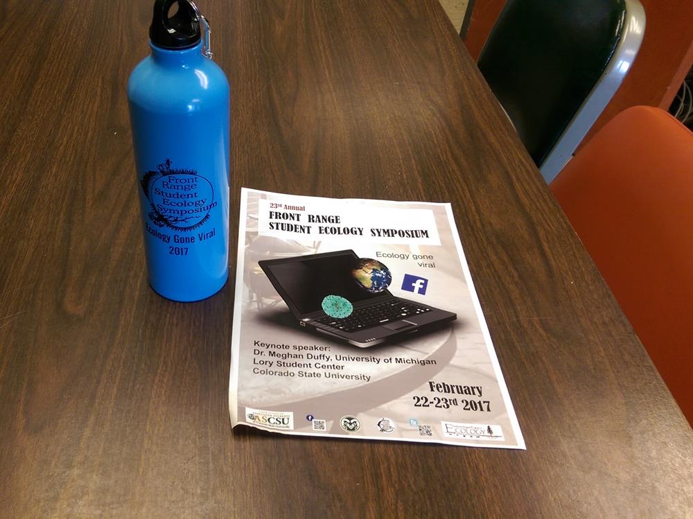 Customer photo from Carolina of our Pacific Aluminum Sport Bottle - 26 oz., a blue water bottle next to a paper on a table