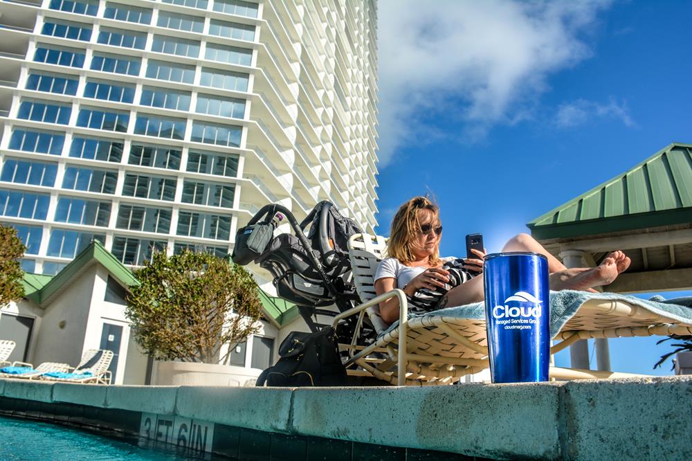 Customer photo from Travis of our Yowie Vacuum Tumbler - 18 oz., a woman sitting on a chair by a pool