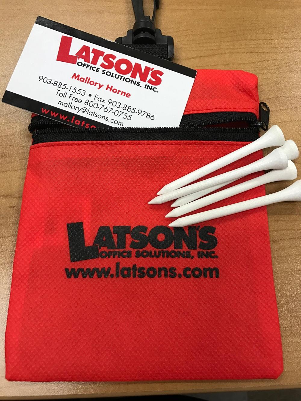 a bag with golf tees and a business card