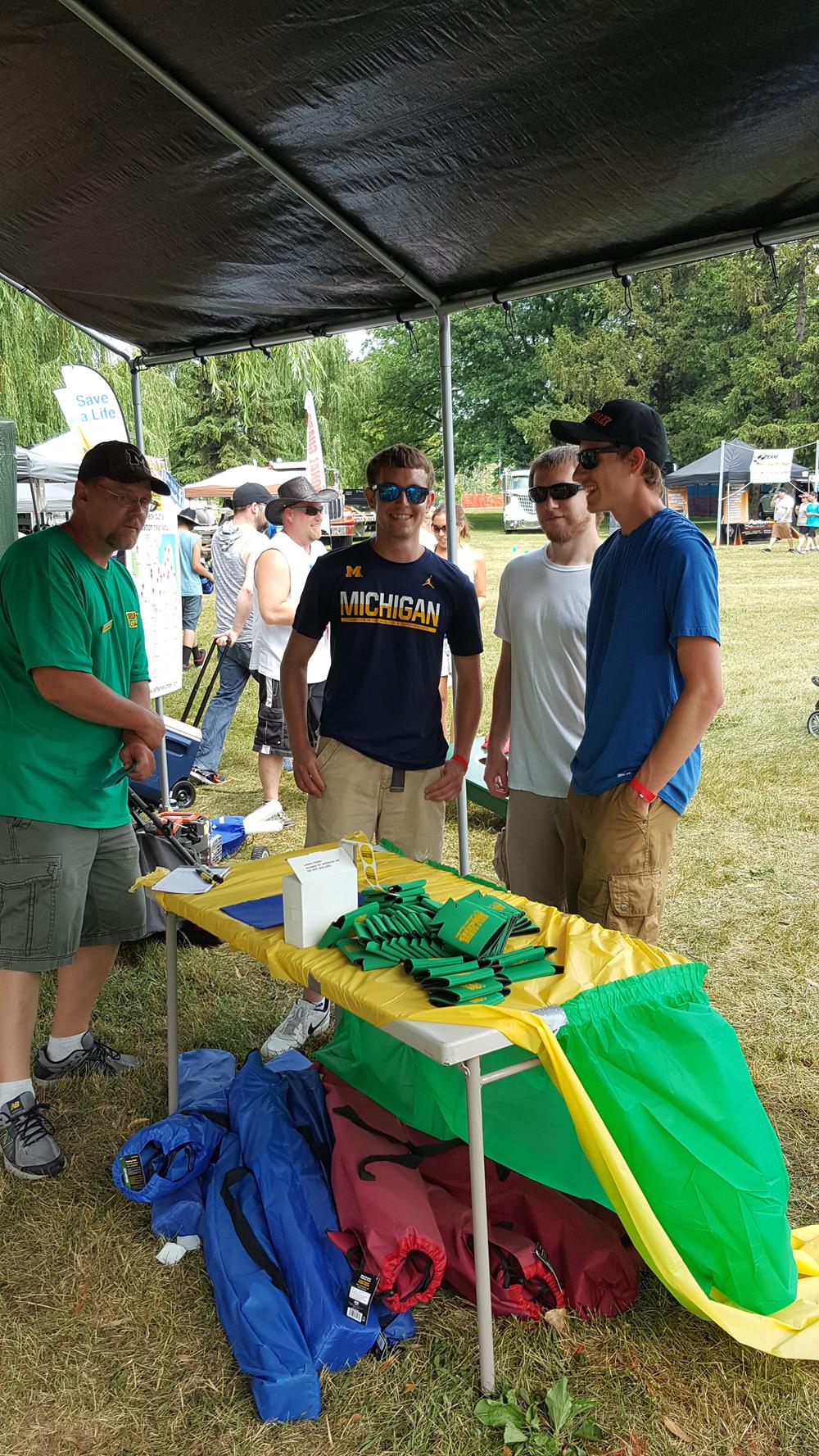 a group of men standing under a tent