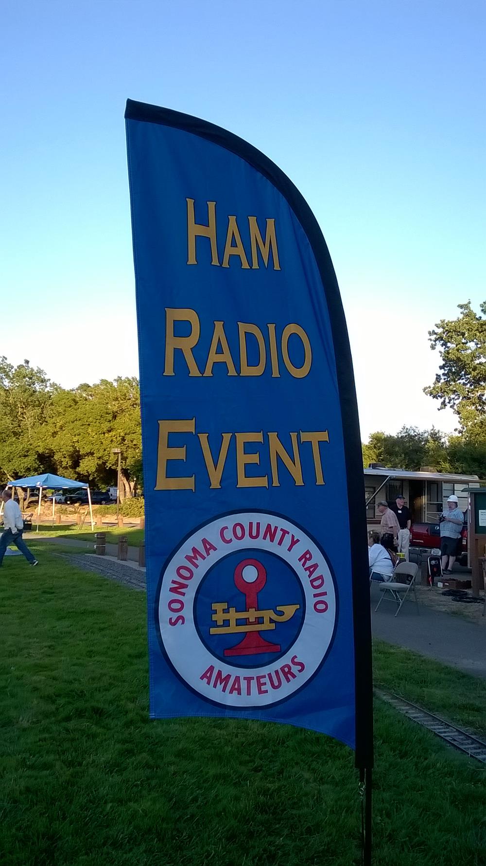 Customer photo from Dan of our Outdoor Razor Sail Sign - 9' - Two Sided, a blue and yellow banner with text
