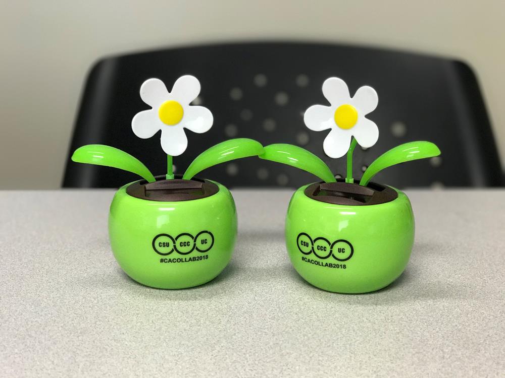 a pair of green planters with white flowers