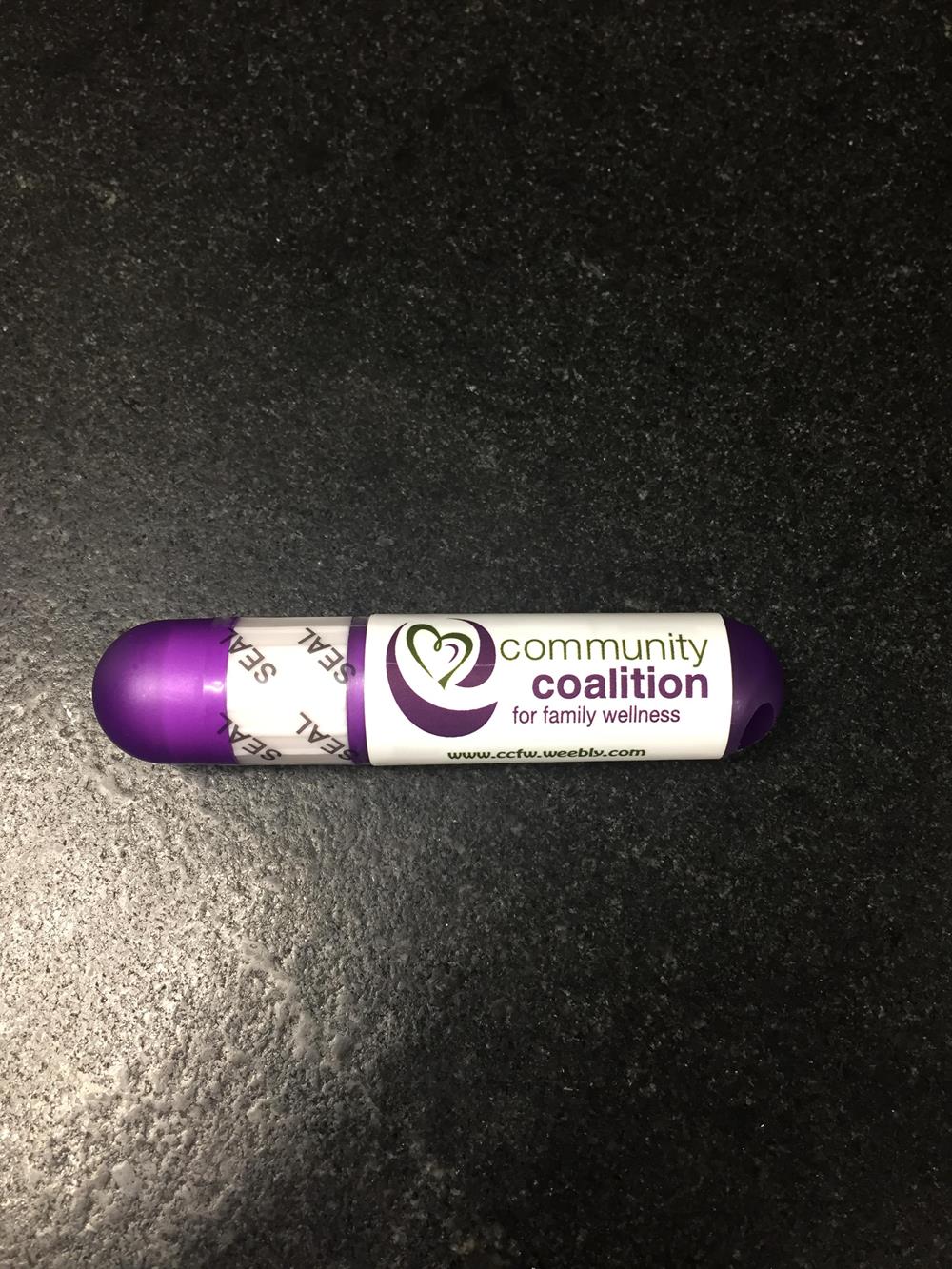 Customer photo from Kara of our Lip Balm Sunscreen Stick - Translucent, a purple and white tube with white text
