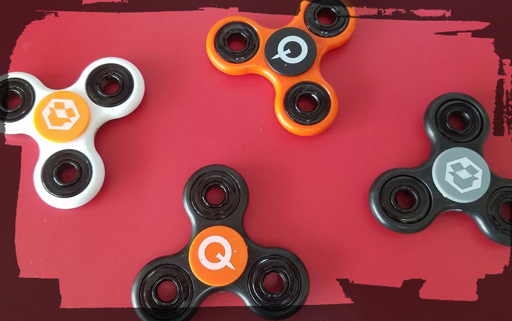 a group of fidget spinners on a red surface