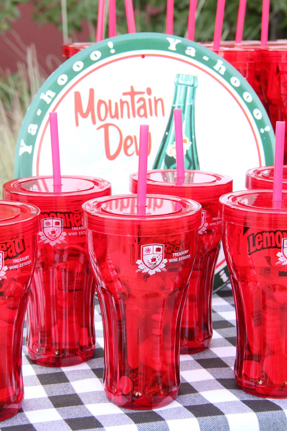 a group of red plastic cups with straws
