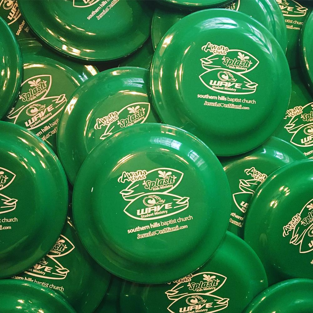 a pile of green frisbees