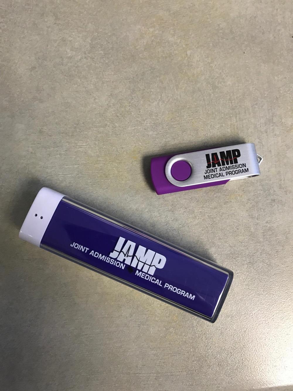 Customer photo from Lauren of our Swing USB Drive - 4GB - 3 Day, a purple and white usb stick next to a purple and white usb stick