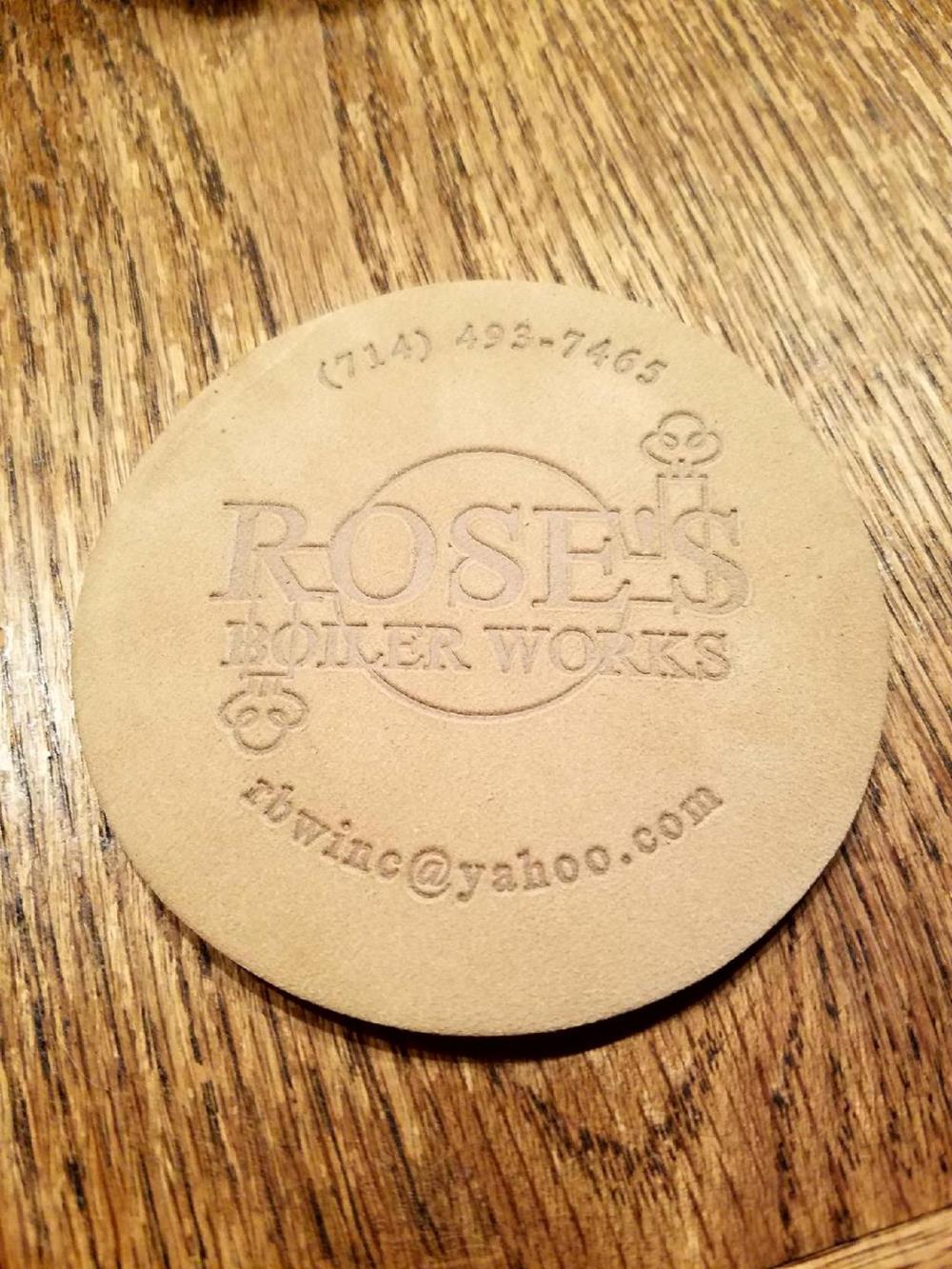 a round brown coaster on a wooden surface