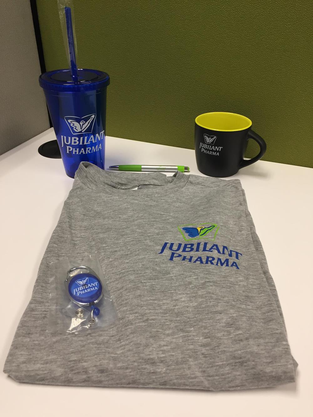 Customer photo from Cheryl of our Clip-On Retractable Badge Holder - Translucent, a t-shirt and a mug on a table