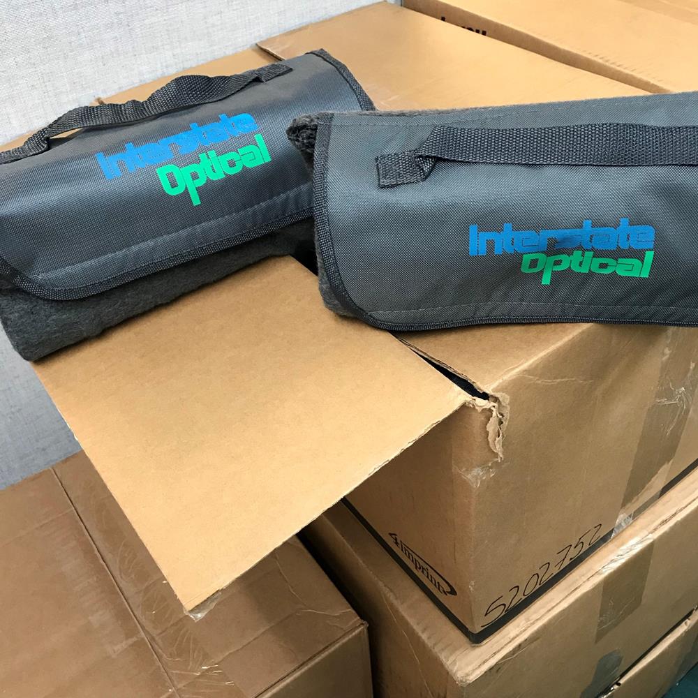 Customer photo from Amanda of our Roll Up Fleece Blanket, a group of boxes with a bag on top