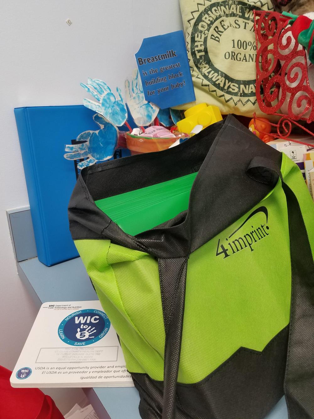 Customer photo from Erin of our Basic 2-Pocket Poly Folder, a green and black bag on a table