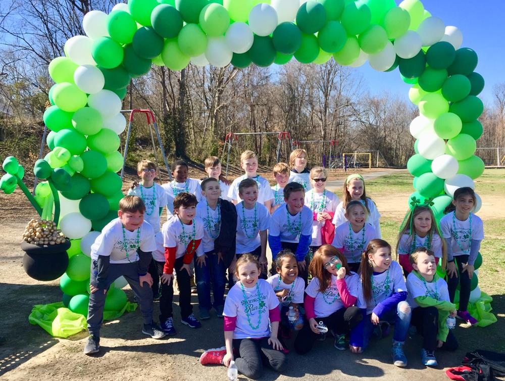 Customer photo from Jennifer of our Hanes Authentic T-Shirt - Screen - White, a group of kids posing for a photo under a balloon arch