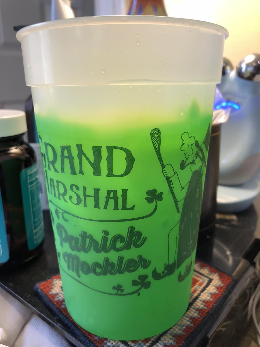 a green drink in a plastic cup