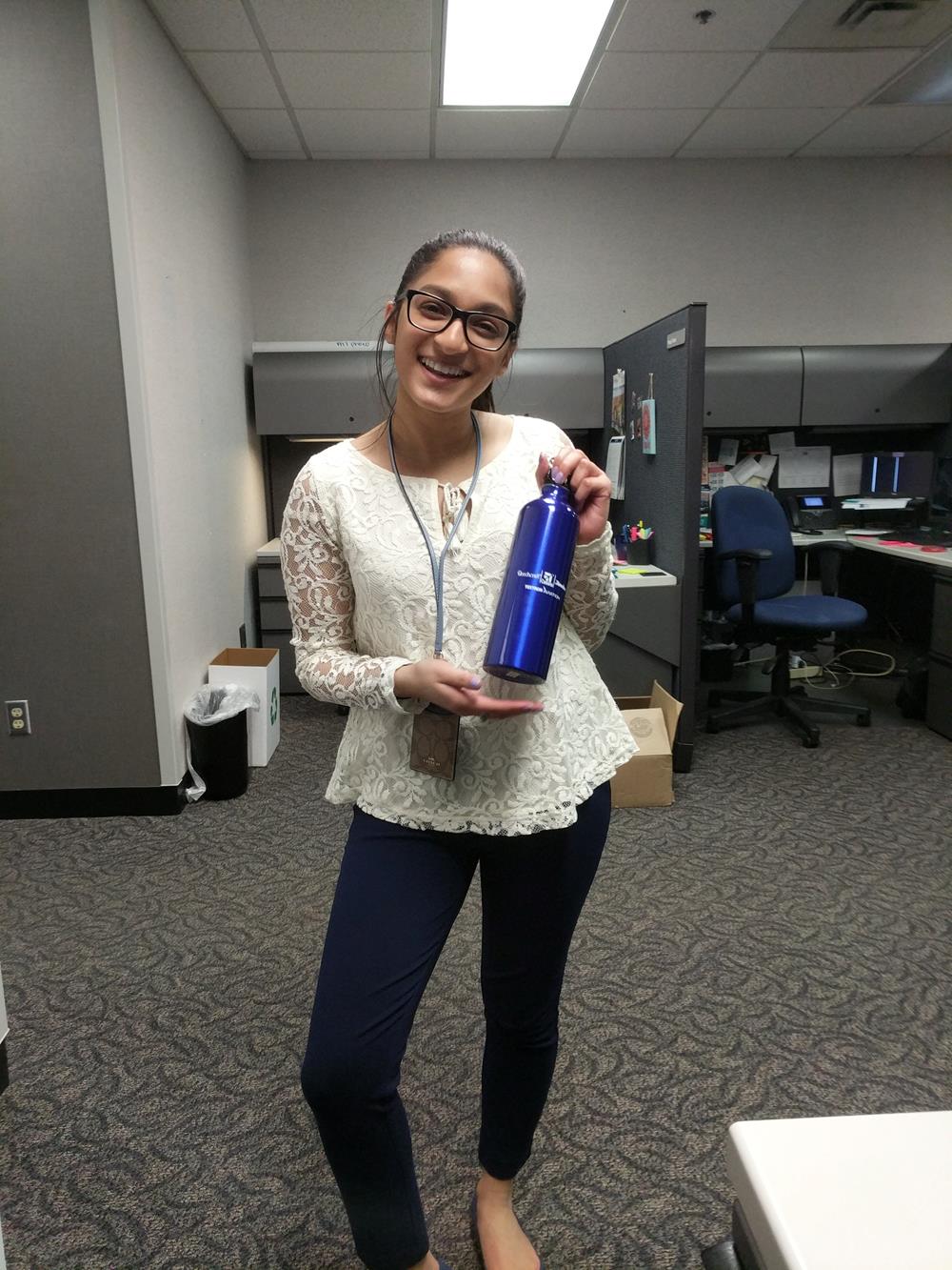 a woman holding a blue water bottle