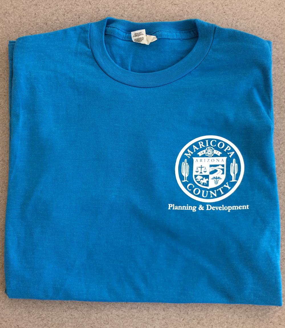 Customer photo from Gerald of our Fashion Heather T-Shirt - Screen, a blue shirt folded on a carpet