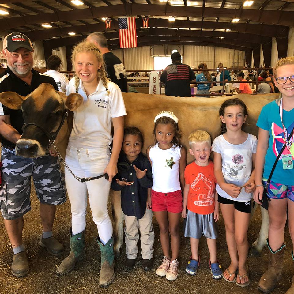 Customer photo from Mary of our Washed Cotton Mesh Back Cap, a group of people standing next to a cow