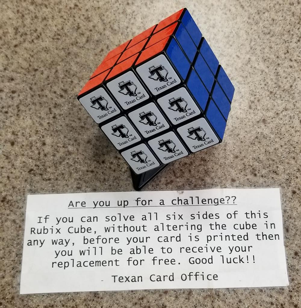 a rubik&#039;s cube with a note