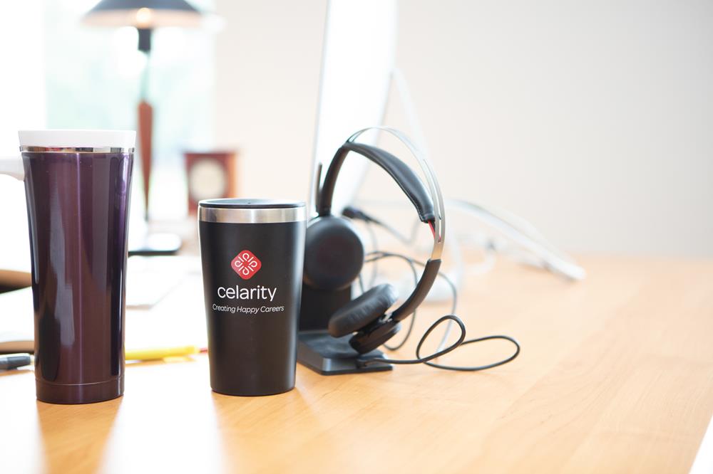 Customer photo from Marlene of our Oxbow Vacuum Travel Tumbler - 16 oz., a cup and headphones on a table