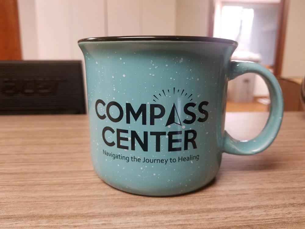Customer photo from Jason of our Campfire Ceramic Mug - Colors - 15 oz. - 24 hr, a blue coffee mug on a table