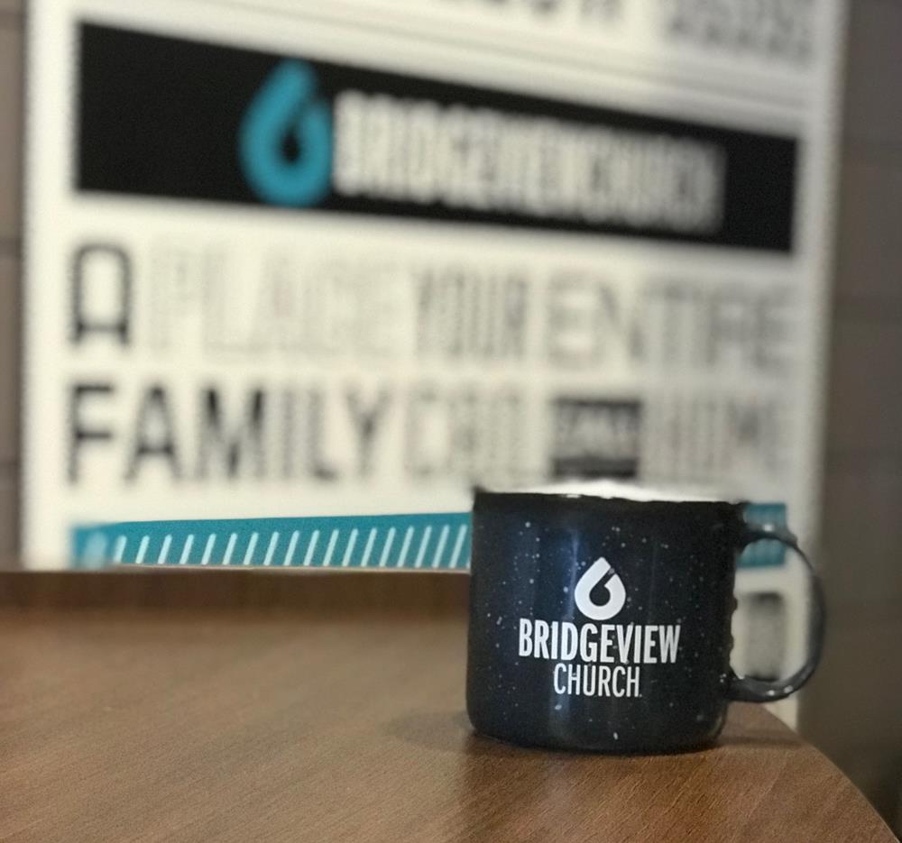 Customer photo from Elizabeth of our Campfire Ceramic Mug - Colors - 15 oz., a coffee mug on a table
