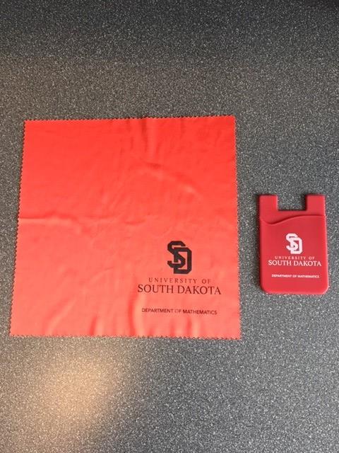 Customer photo from Betsy of our Adhesive Cell Phone Wallet, a red rectangular object next to a red cloth