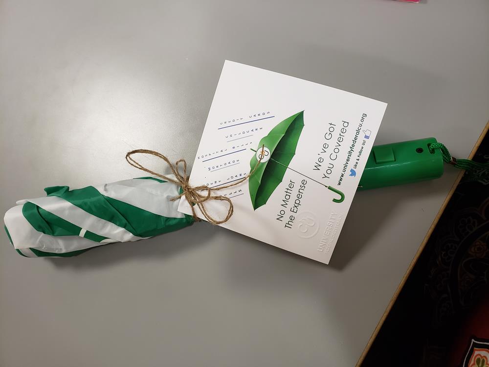 a green umbrella with a card on it