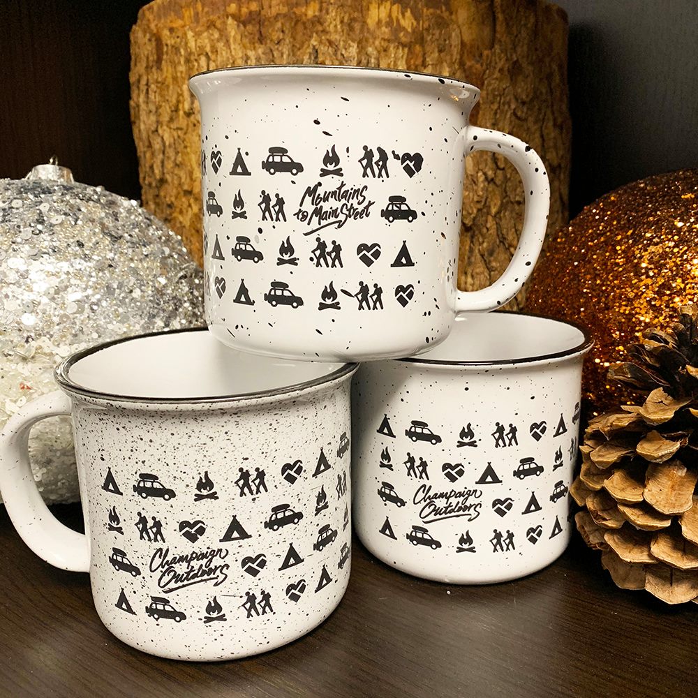 Customer photo from Shira of our Campfire Ceramic Mug - White - 15 oz., a stack of mugs with designs on them
