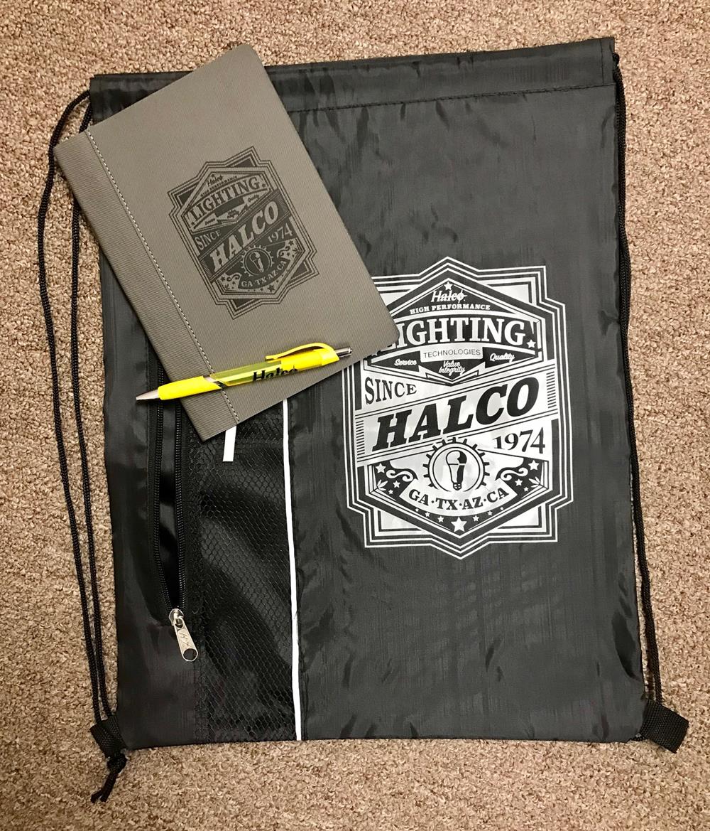 a bag with a pen and a notebook on it
