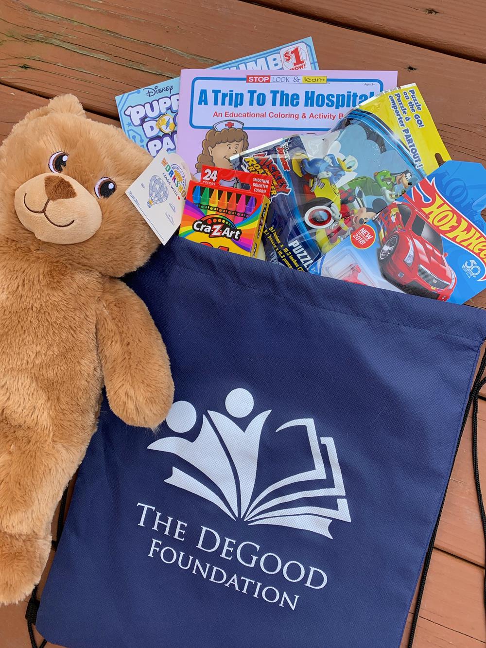 a stuffed bear and a bag of books