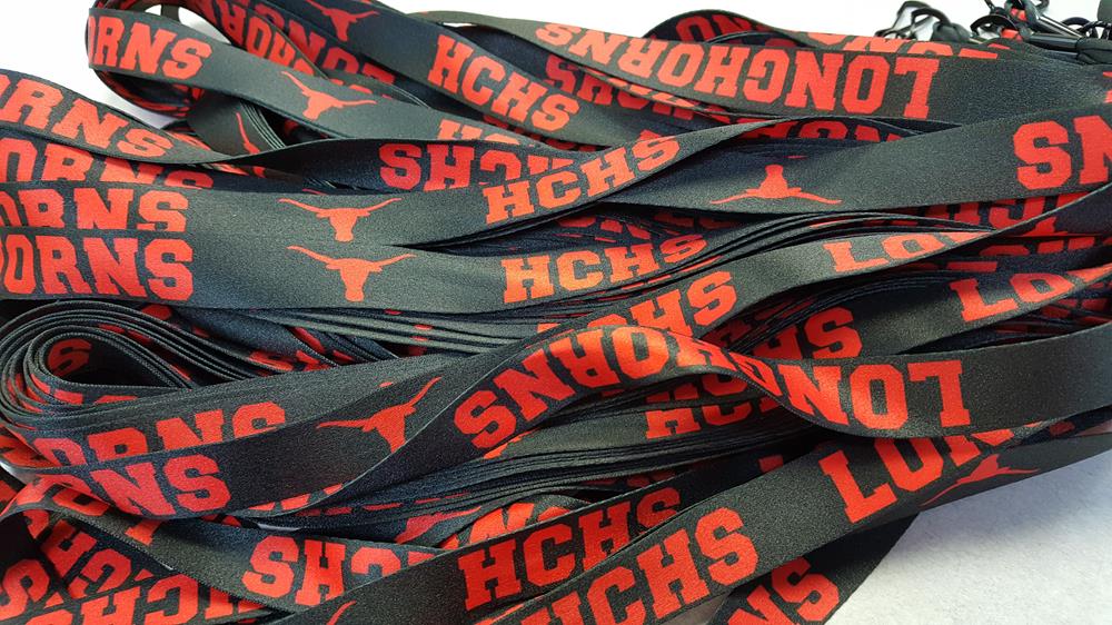 a bunch of black lanyards with red text