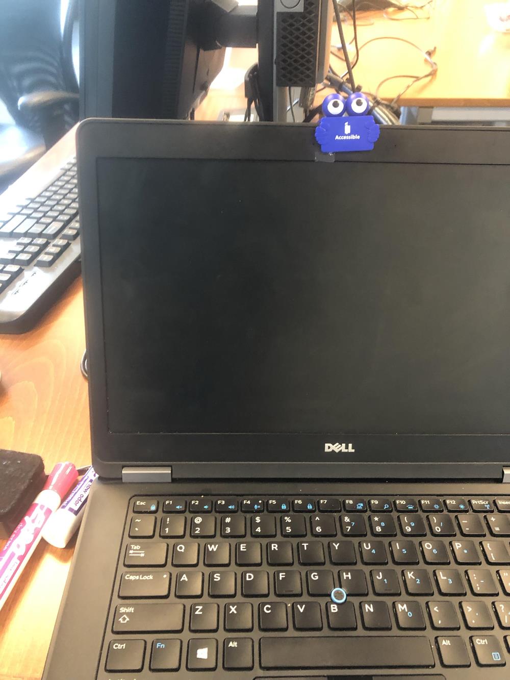 Customer photo from Jasmine of our Clipster Webcam Privacy Cover, a laptop with a blue sticker attached to it