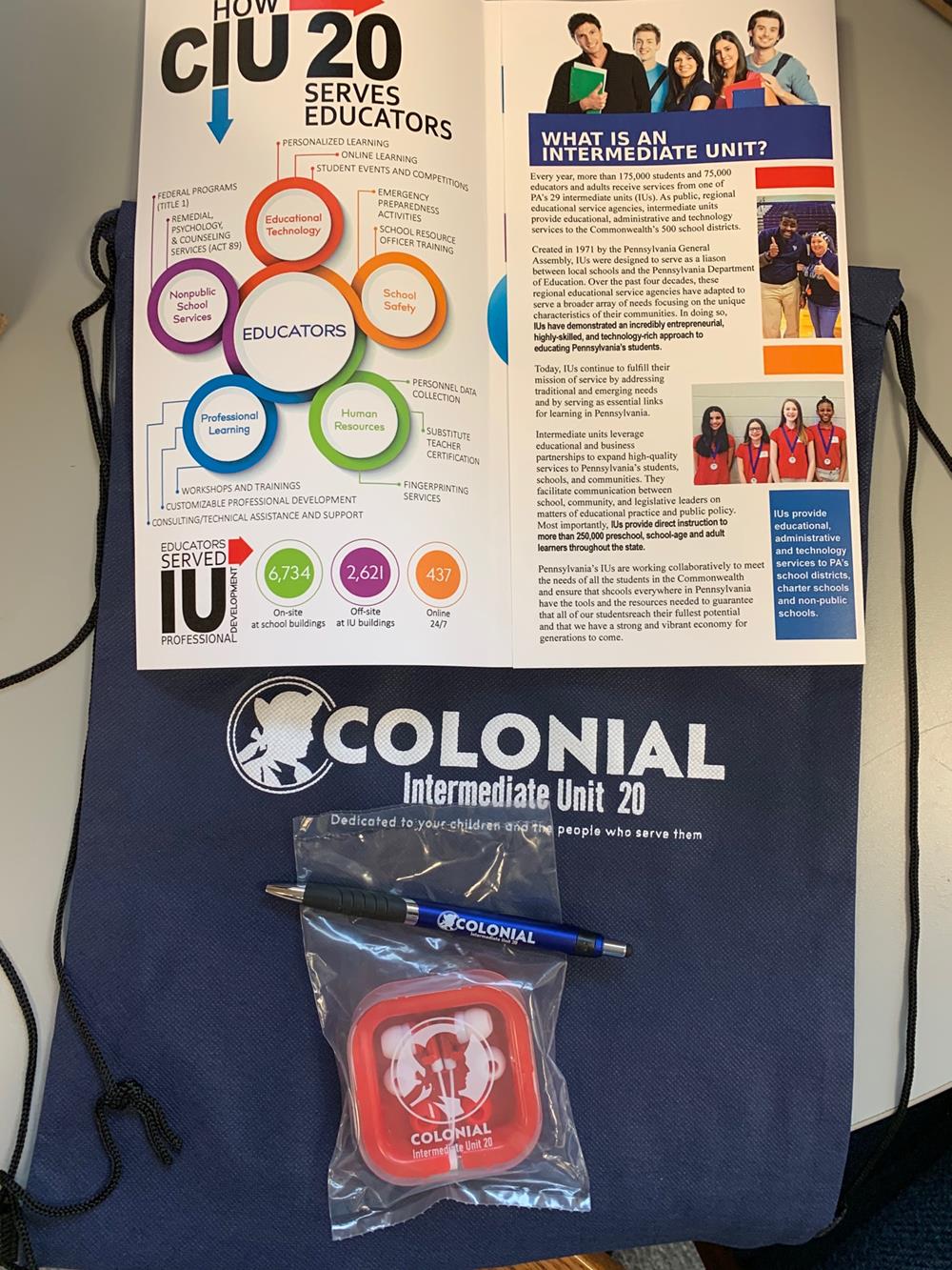 Customer photo from Christiana of our Ear Buds with Interchangeable Covers - Colors, a book and pen on a table