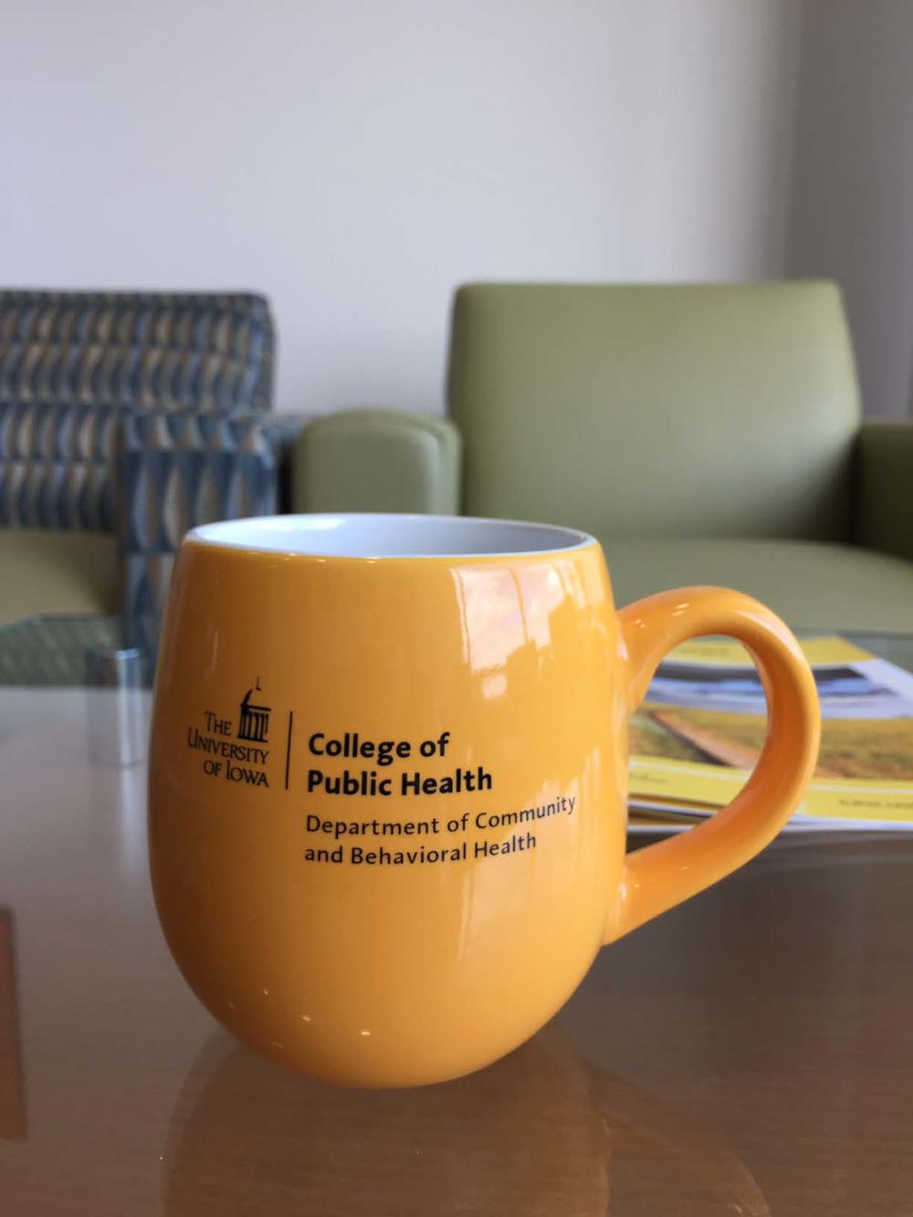 Customer photo from Yu-Hsin of our Rotondo Coffee Mug - 16 oz., a yellow coffee mug on a table