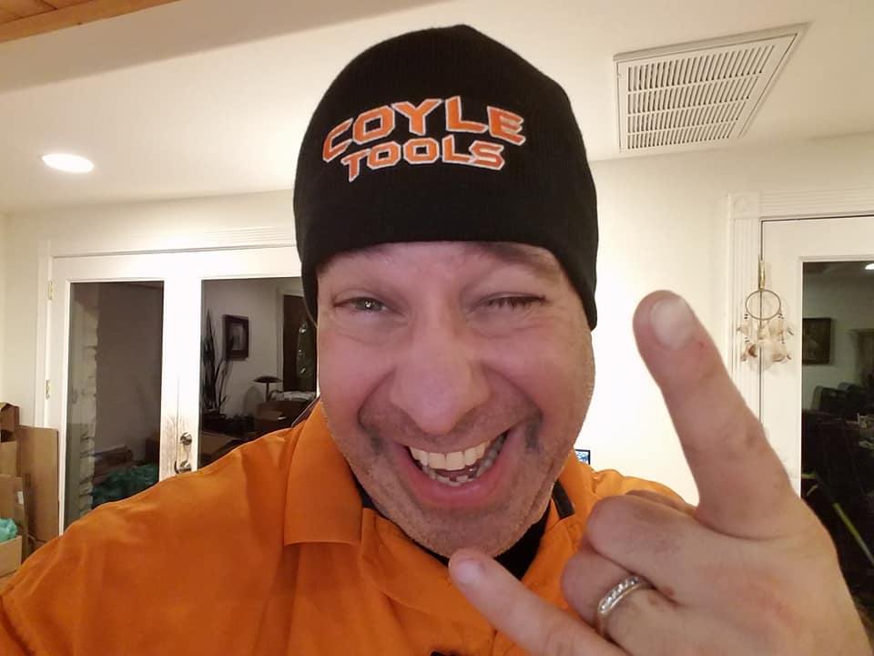 Customer photo from Kathleen of our Level Knit Beanie, a man wearing a hat and holding up his hand