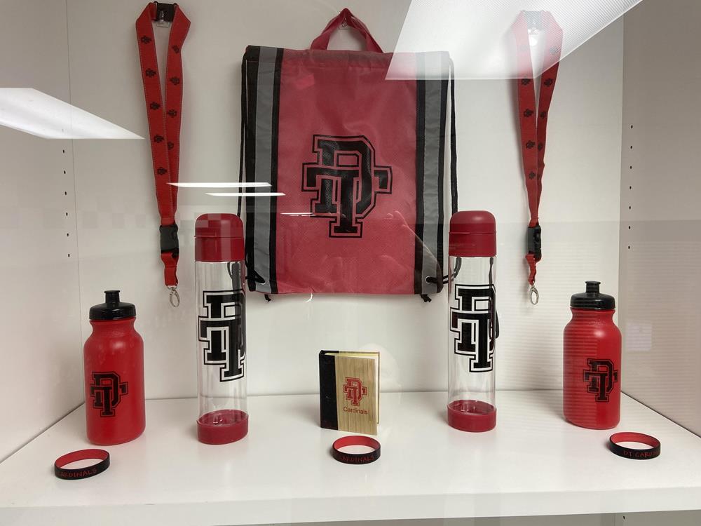 Customer photo from Rodney of our Essence Bamboo Desk Set, a group of red water bottles and a red bag