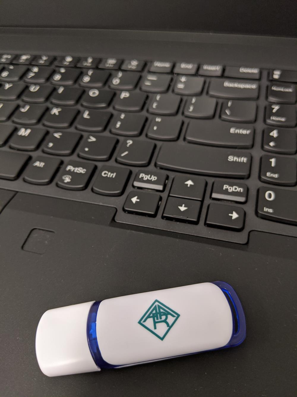 a usb flash drive on a laptop keyboard
