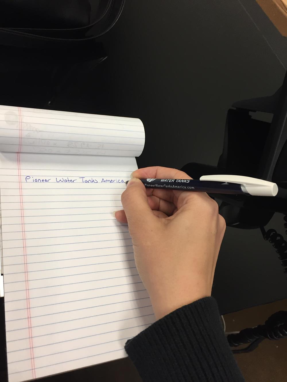 Customer photo from Jessica of our Bic Media Clic Pen - Opaque, a hand holding a pen and writing on a notebook