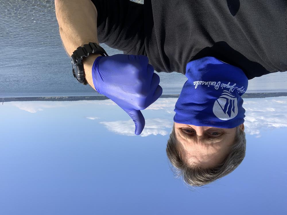Customer photo from Steve of our The Fandana, a man wearing a blue bandana and gloves