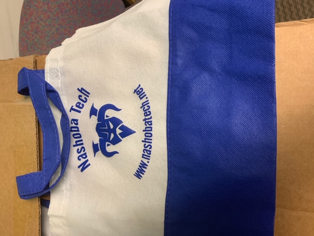 Customer photo from Jane of our Aruba Tote, a white and blue bag with blue text