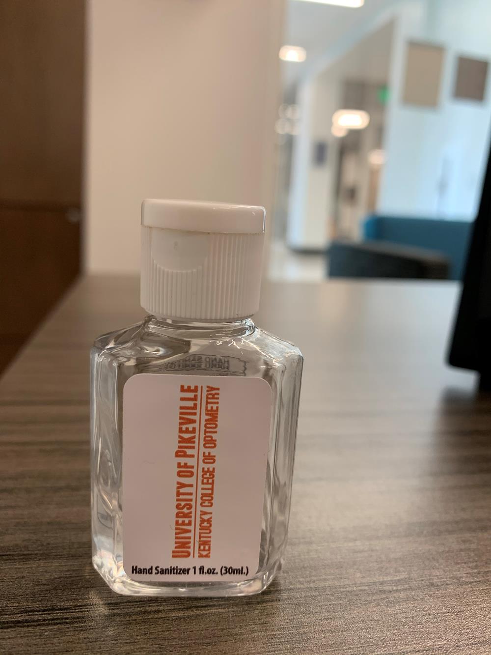 Customer photo from Jennifer of our Protector Hand Sanitizer - 1 oz., a small bottle of liquid on a table