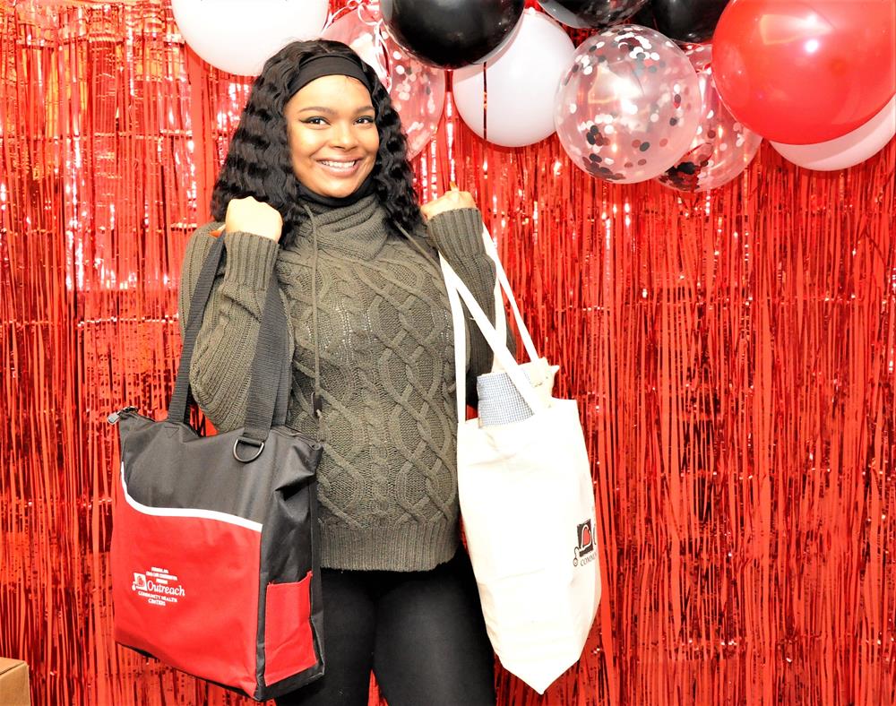 Customer photo from Crystal of our Titro Tote - Embroidered, a woman holding bags and smiling