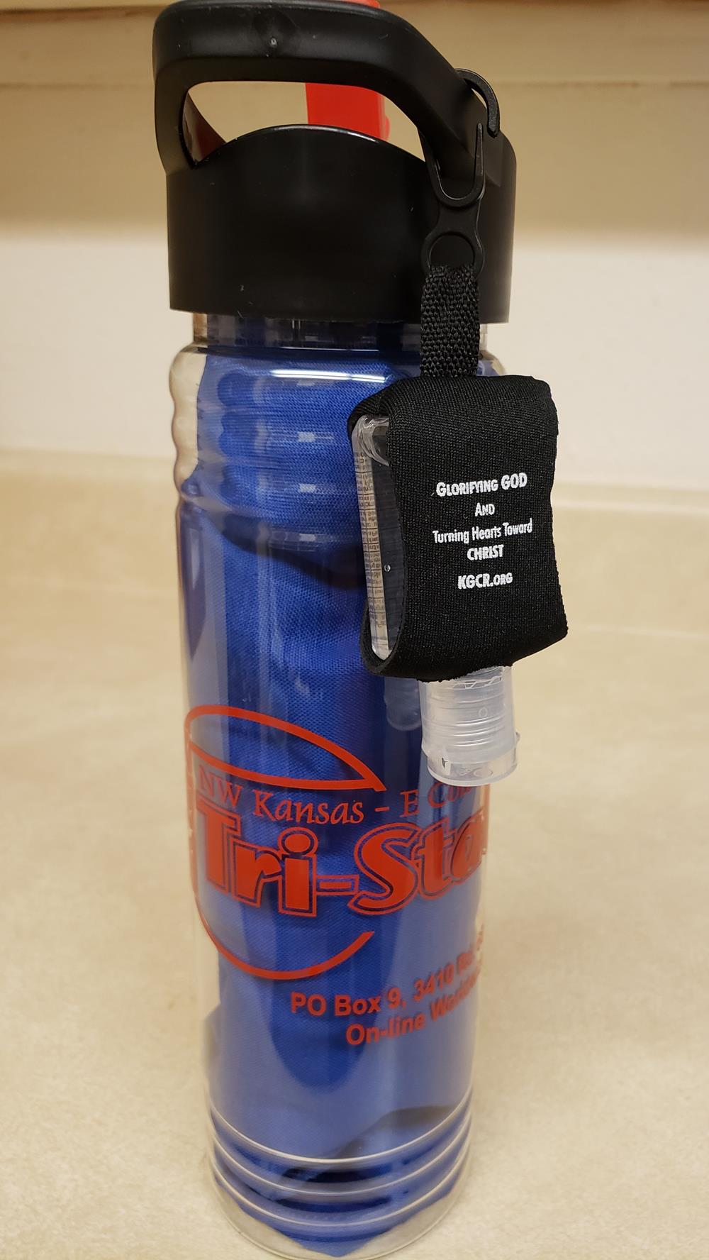 a blue water bottle with a black strap