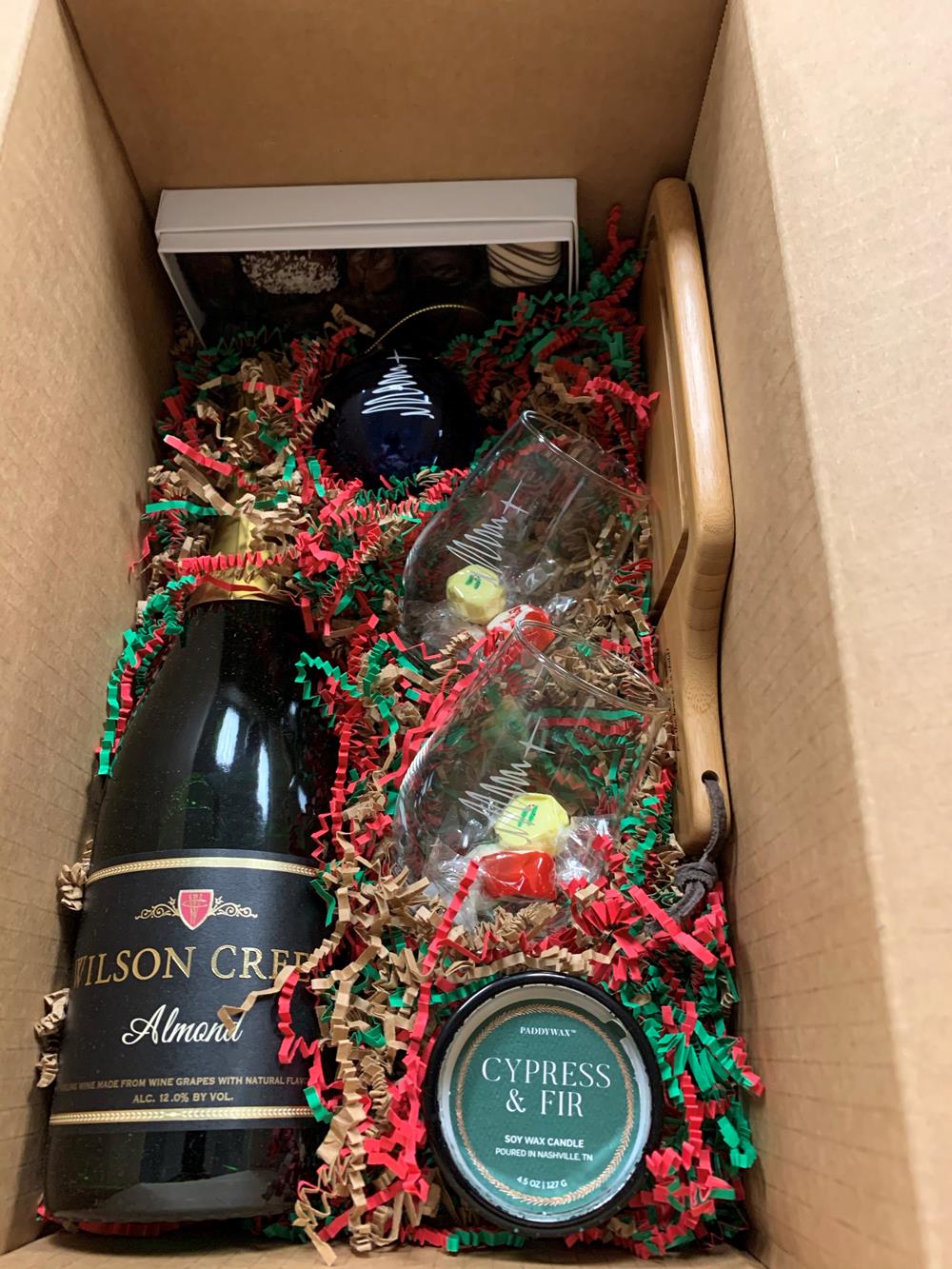 Customer photo from Luz of our Mini Everyday Bamboo Cutting Board, a box with a bottle and other objects