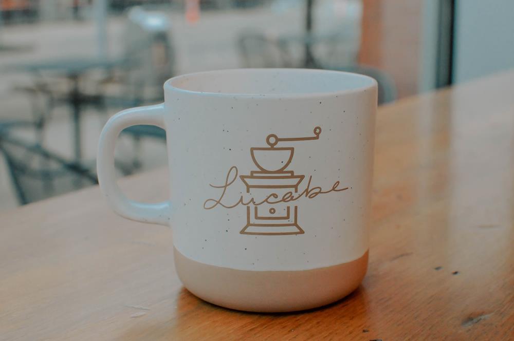Customer photo from John of our Santos Coffee Mug - 11 oz., a white coffee mug with a logo on it