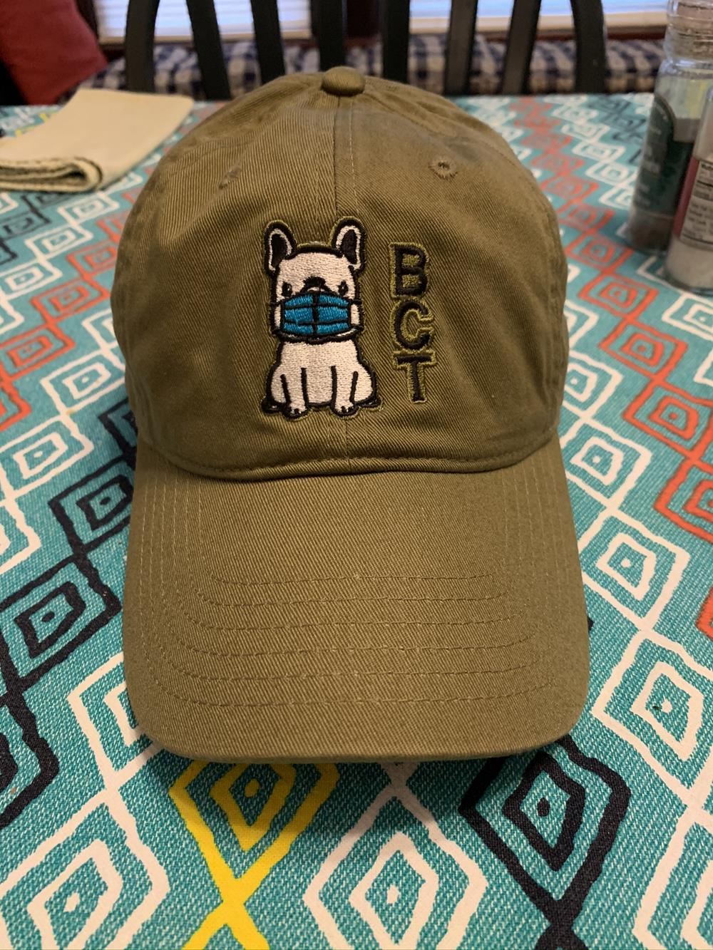 a green hat with a dog on it