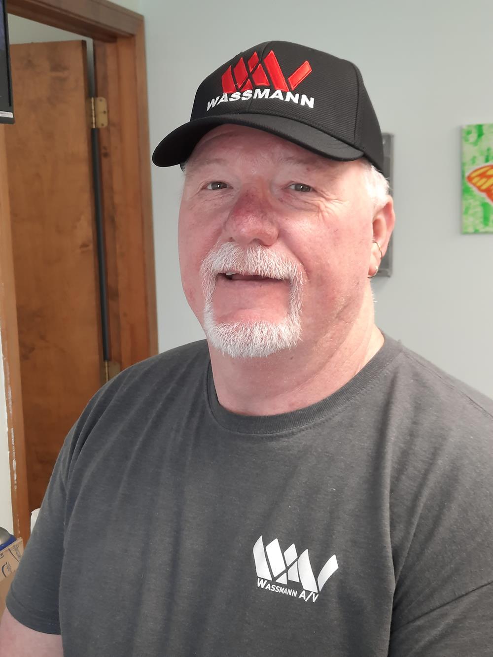Customer photo from Barbara of our Performance Textured Snapback Cap, a man wearing a hat